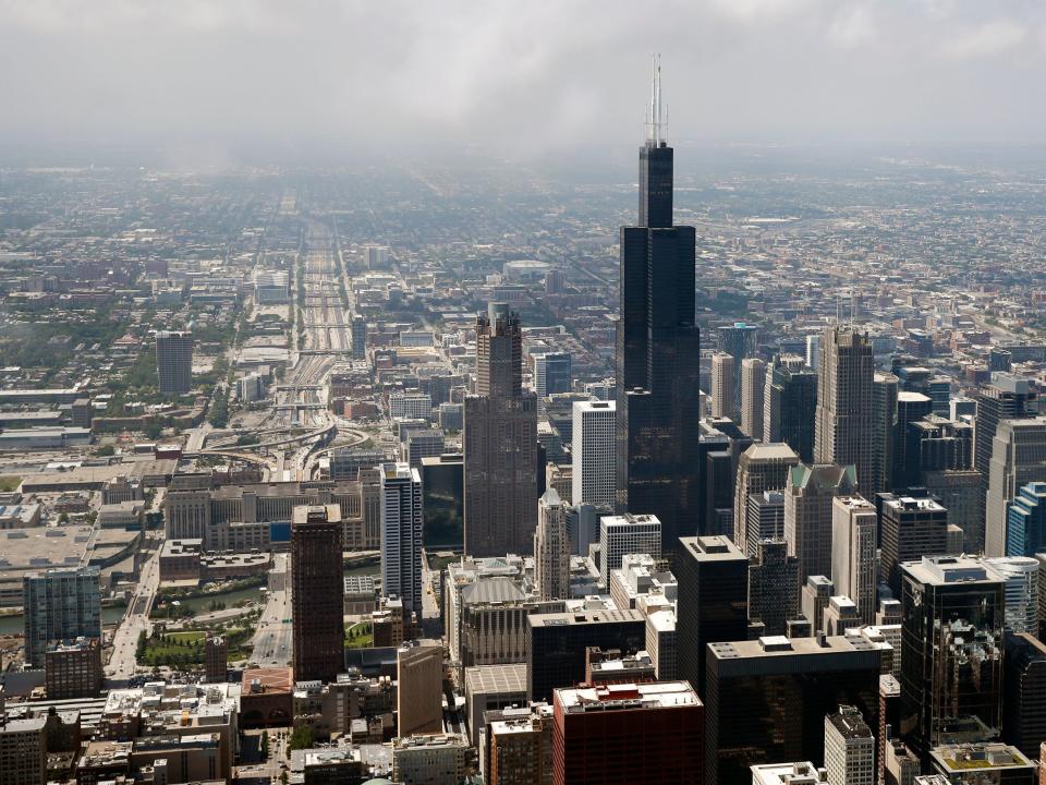 An aerial view of the Chicago skyline, with the Willis Tower towering over the city.