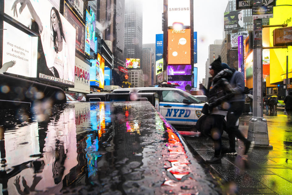 People walk around Times Square during a winter storm in New York, Sunday, Jan. 7, 2024. (AP Photo/Eduardo Munoz Alvarez)