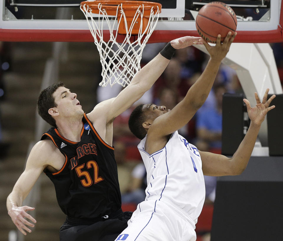 Duke forward Jabari Parker (1) shoots against Mercer forward Daniel Coursey (52) during the first half of an NCAA college basketball second-round game, Friday, March 21, 2014, in Raleigh, N.C. (AP Photo/Chuck Burton)