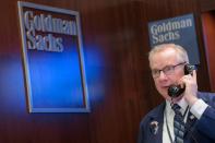 FILE PHOTO: A trader works inside the Goldman Sachs booth on the floor of the NYSE in New York
