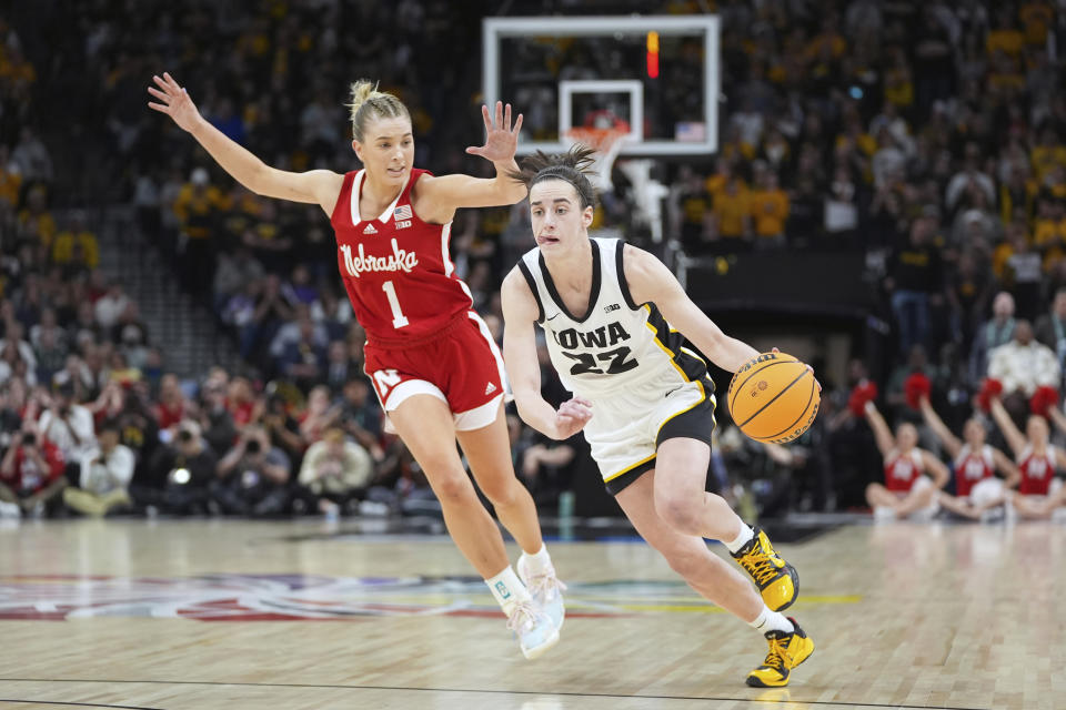 Iowa guard Caitlin Clark (22) works toward the basket as Nebraska guard Jaz Shelley (1) defends during the second half of an NCAA college basketball game in the final of the Big Ten women's tournament Sunday, March 10, 2024, in Minneapolis. (AP Photo/Abbie Parr)