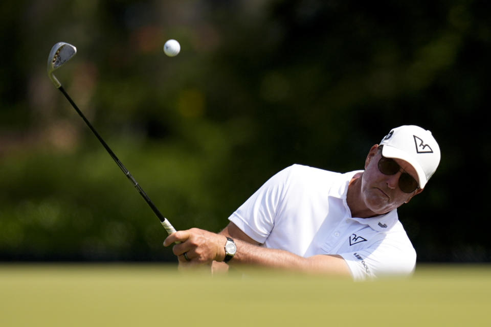 CORRECTS DATE - Phil Mickelson chips to the green on the eighth hole during a practice round for the U.S. Open golf tournament, Wednesday, June 12, 2024, in Pinehurst, N.C. (AP Photo/Mike Stewart)