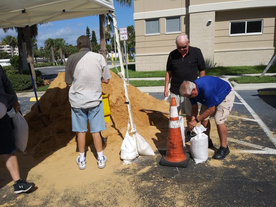 Residents fill sand bags outside Daytona Beach Shores City Hall as preparations continue for Tropical Storm Ian.