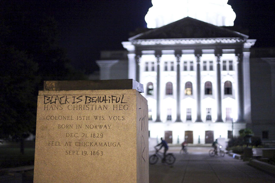 The base of a statue of Col. Hans Christian Heg, a Union Civil War colonel who fought for the end of slavery, remains after it was torn down by protesters during demonstrations in Madison, Wis. Tuesday, June 23, 2020. Crowds outside the Wisconsin State Capitol tore down two statues and attacked a state senator amid protests following the arrest of a Black man who shouted at restaurant customers through a megaphone while carrying a baseball bat. (Emily Hamer/Wisconsin State Journal via AP)