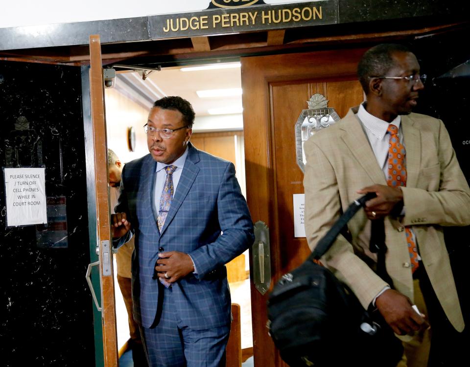 The Rev. Derrick Scobey, left, leaves the courtroom of Oklahoma County District Court Judge Perry Hudson as the Rev. Clarence Hill stands outside the door on Friday in Oklahoma City.