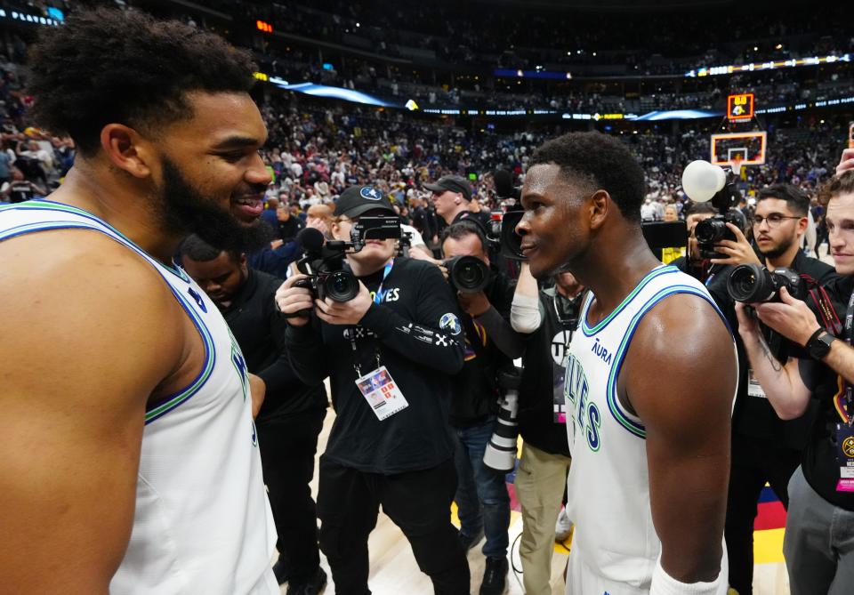 Minnesota Timberwolves center Karl-Anthony Towns (left) and Anthony Edwards celebrate defeating the Denver Nuggets in Game 7 of the second round NBA playoffs at Ball Arena.