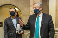 White House chief of staff Mark Meadows, right, and Treasury Secretary Steven Mnuchin, arrive at the office of House Speaker Nancy Pelosi at the Capitol to resume talks on a COVID-19 relief bill, Saturday, Aug. 1, 2020, in Washington. (AP Photo/Manuel Balce Ceneta)