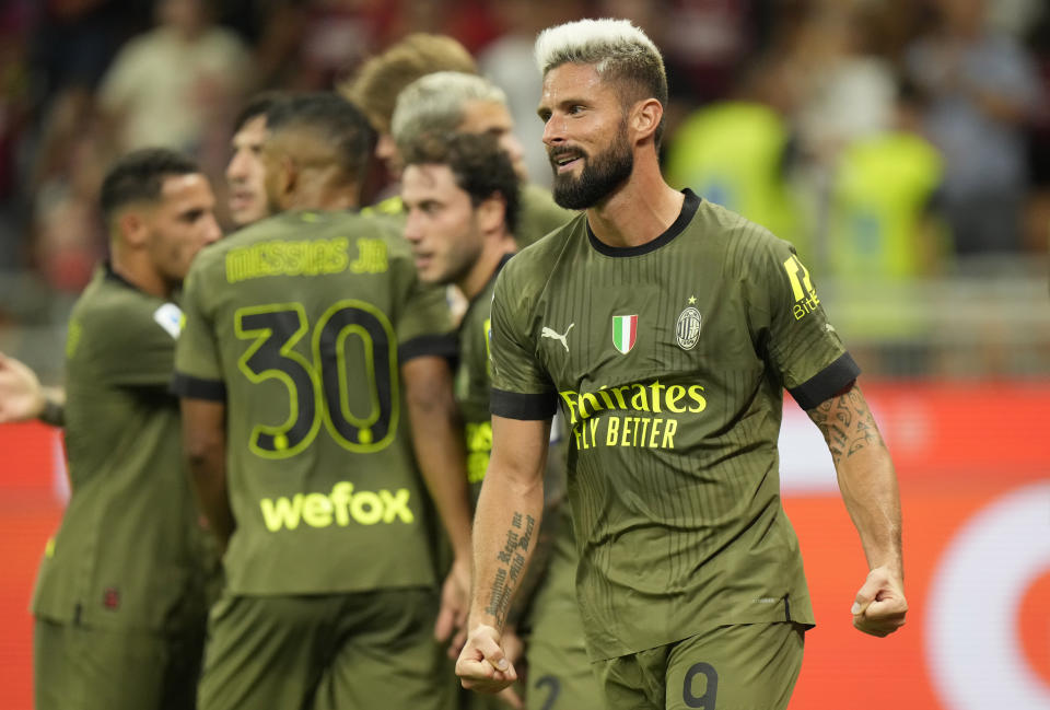 AC Milan's Olivier Giroud celebrates after scoring his side's second goal during a Serie A soccer match between AC Milan and Bologna at the San Siro stadium in Milan, Italy, Saturday, Aug. 27, 2022. (AP Photo/Luca Bruno)