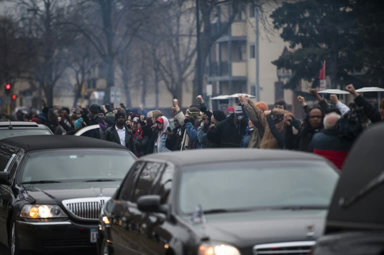 Demonstrators protest the fatal police shooting of Jamar Clark, 24, who they said was handcuffed when he was shot in the head on November 15, during Clark's funeral procession outside a Minneapolis police station on November 25, 2015