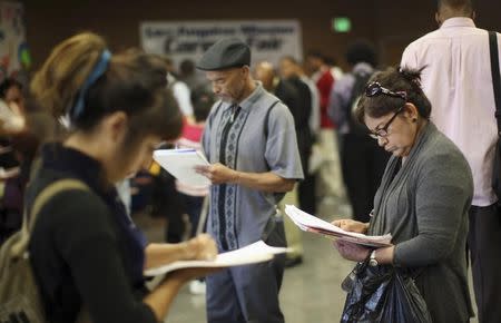 Job seekers fill out applications during the 11th annual Skid Row Career Fair the Los Angeles Mission in Los Angeles, California, May 31, 2012. REUTERS/David McNew/File Photo