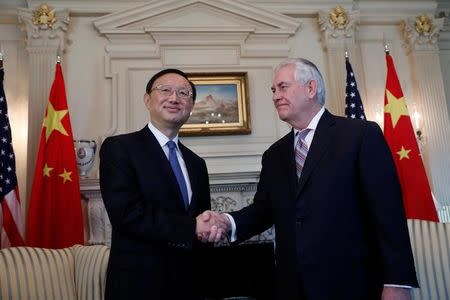 Secretary of State Rex Tillerson greets Chinese State Councilor Yang Jiechi at the State Department in Washington, U.S., February 28, 2017. REUTERS/Aaron P. Bernstein