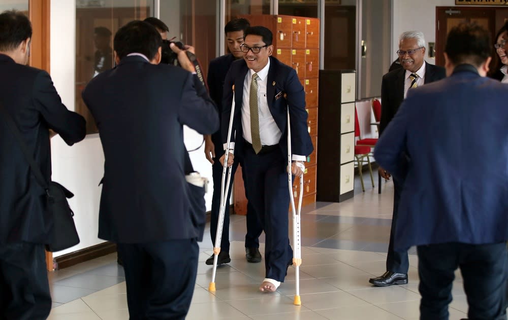 Perak Mentri Besar Datuk Seri Ahmad Faizal Azumu walking with crutches to the state legislative assembly in Ipoh July 23, 2019. — Picture by Farhan Najib