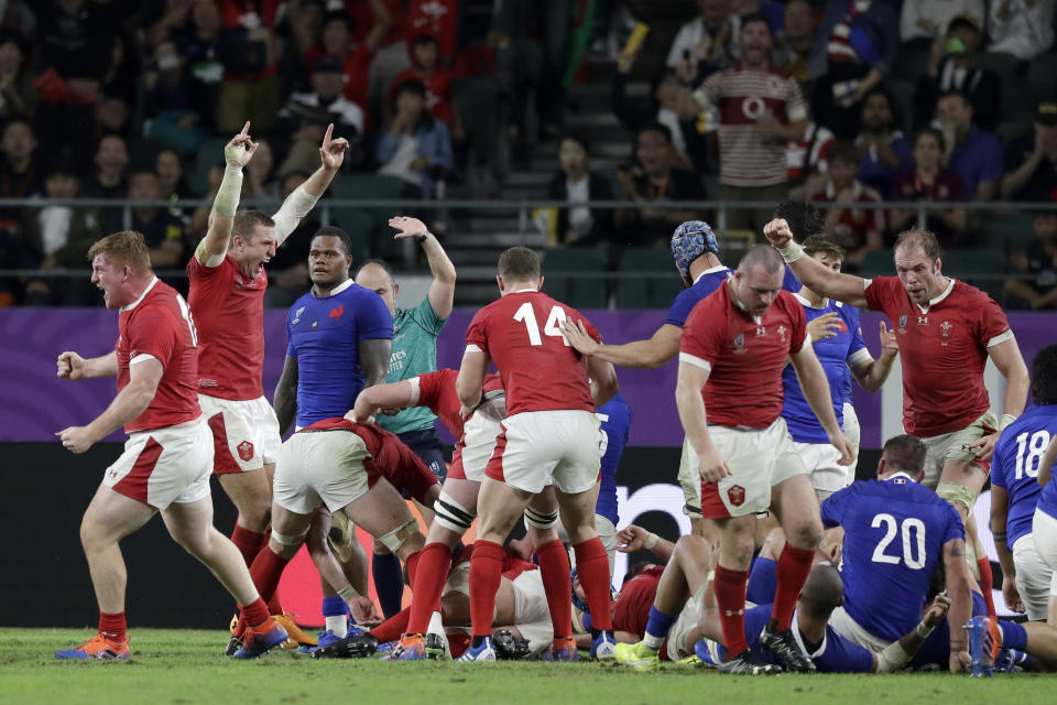Wales players react after Wales' Ross Moriarty scores a try during the Rugby World Cup quarterfinal match at Oita Stadium between Wales and France in Oita, Japan, Sunday, Oct. 20, 2019. (AP Photo/Aaron Favila)
