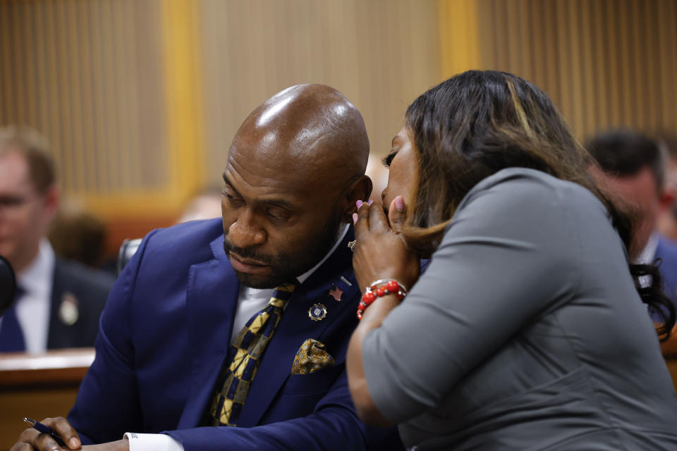 Special prosecutors Nathan Wade, left, and Daysha Young talk amongst themselves during a hearing on the Georgia election interference case, Friday, March, 1, 2024, in Atlanta. The hearing is to determine whether Fulton County District Attorney Fani Willis should be removed from the case because of a relationship with Nathan Wade, special prosecutor she hired in the election interference case against former President Donald Trump. (AP Photo/Alex Slitz, Pool)