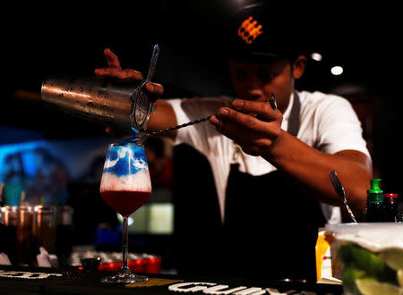 A bartender prepares "Trump", a special drink offered at Escobar bar to mark the summit meeting between U.S. President Donald Trump and North Korean leader Kim Jong Un, in Singapore June 4, 2018. REUTERS/Edgar Su