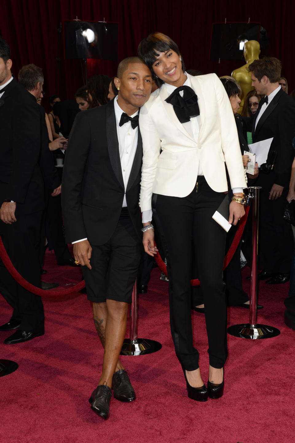 Pharrell Williams, left, and Helen Lasichanh arrive at the Oscars on Sunday, March 2, 2014, at the Dolby Theatre in Los Angeles. (Photo by Dan Steinberg/Invision/AP)