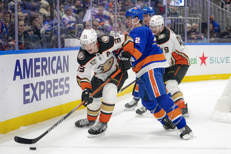 New York Islanders defenseman Mike Reilly (2) checks Anaheim Ducks right wing Jakob Silfverberg (33) during the third period of an NHL hockey game in Elmont, N.Y., Wednesday, Dec. 13, 2023. The Islanders won, 4-3. (AP Photo/Peter K. Afriyie)