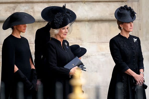 LONDON, ENGLAND - SEPTEMBER 19: Meghan, Duchess of Sussex, Camilla, Queen Consort, Princess Charlotte of Wales and Sophie, Countess of Wessex watch on as The Queen's funeral cortege borne on the State Gun Carriage of the Royal Navy as it departs Westminster Abbey on September 19, 2022 in London, England. Elizabeth Alexandra Mary Windsor was born in Bruton Street, Mayfair, London on 21 April 1926. She married Prince Philip in 1947 and ascended the throne of the United Kingdom and Commonwealth on 6 February 1952 after the death of her Father, King George VI. Queen Elizabeth II died at Balmoral Castle in Scotland on September 8, 2022, and is succeeded by her eldest son, King Charles III.  (Photo by Christopher Furlong/Getty Images)