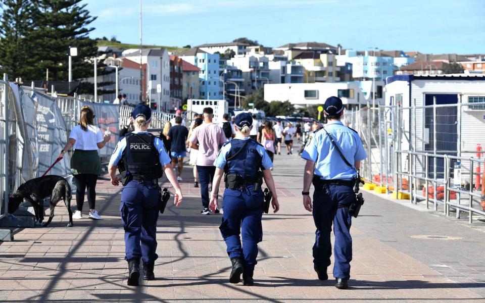 Police patrol near Bondi Beach in Sydney, as authorities announced that millions of residents will spend another month in lockdown due to a growing Covid-19 outbreak, on 28 July 2021 - Saeed Khan/AFP