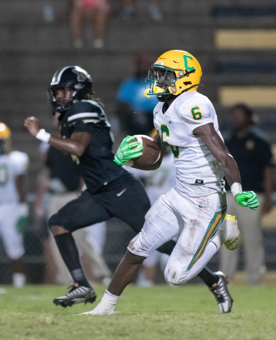 Ja'bril Rawls (6) returns the ball before having it dislodged by Matthew Farrar (4) and turning it over to the Panthers during the Pensacola Catholic vs Milton football game at Milton High School on Thursday, Sept. 1, 2022.