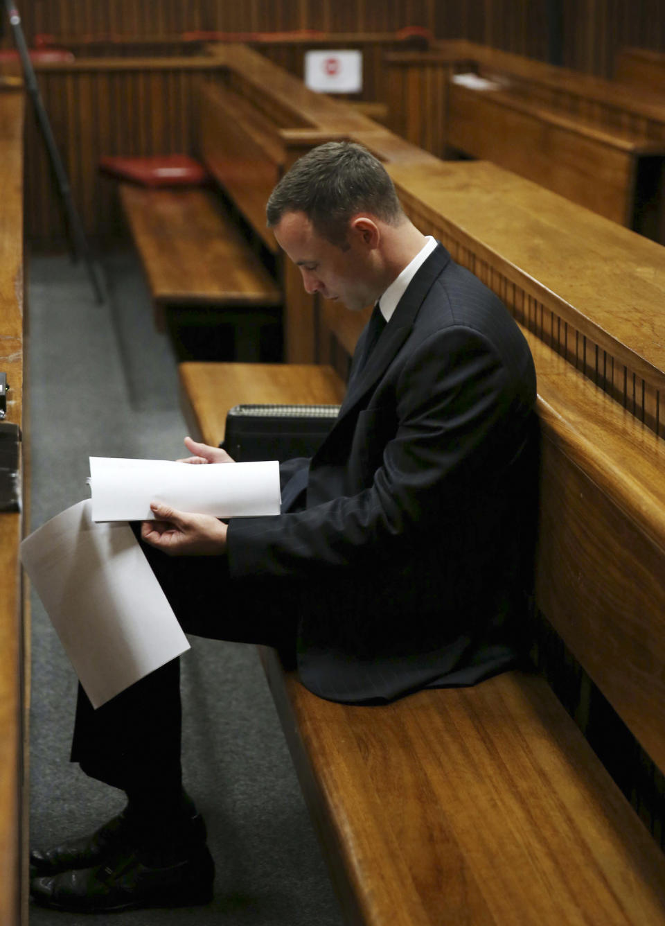 Oscar Pistorius sits in the dock at a court in Pretoria, South Africa, Tuesday, March 25, 2014. Pistorius is charged with the Valentines Day 2013 shooting death of his girlfriend Reeva Steenkamp. (AP Photo/Esa Alexander, Pool)
