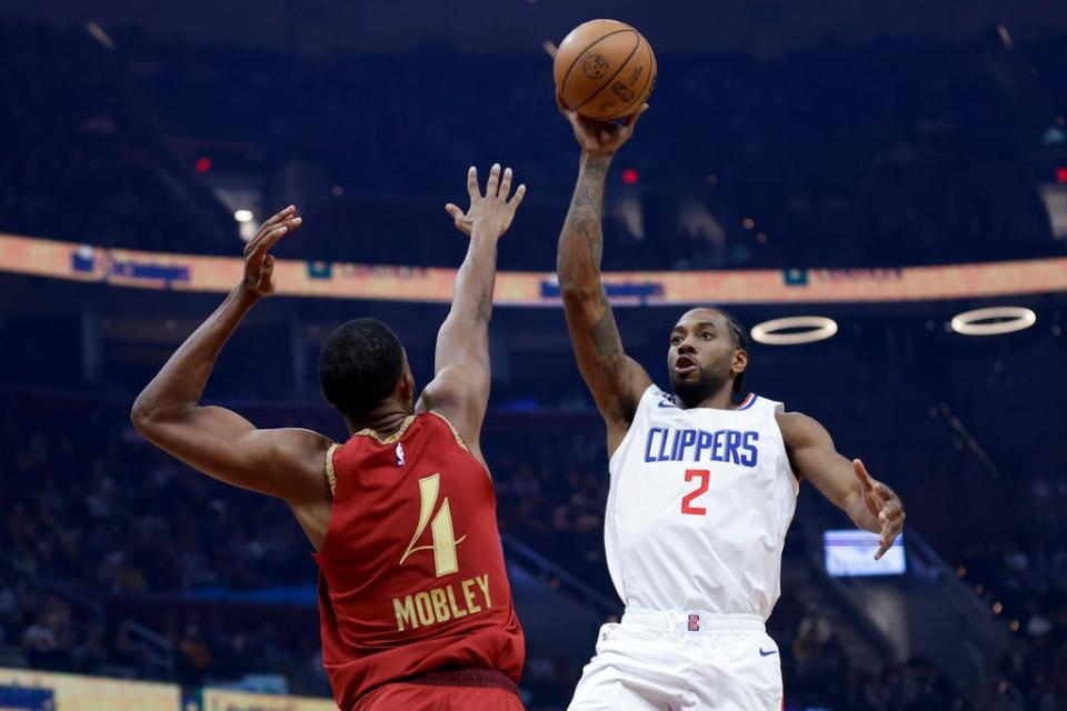 Los Angeles Clippers forward Kawhi Leonard (2) shoots against Cleveland Cavaliers forward Evan Mobley (4) during the first half of an NBA basketball game, Monday, Jan. 29, 2024, in Cleveland. (AP Photo/Ron Schwane)