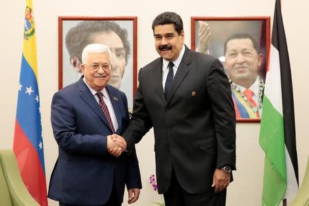 Venezuela's President Nicolas Maduro (R) shakes hands with Palestinian President Mahmoud Abbas in Porlamar, Venezuela September 16, 2016. Miraflores Palace/Handout via REUTERS