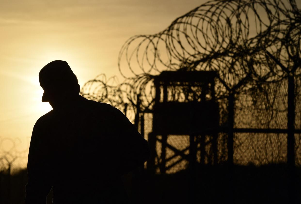 A US soldier walks next to the razor wire-topped fence at the abandoned ‘Camp X-Ray’ detention facility (Mladen ANTONOV / AFP)