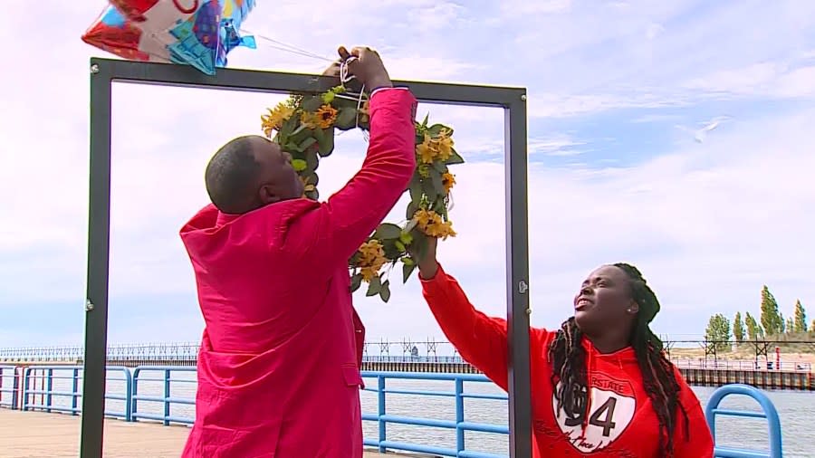 Benton Harbor Mayor Marcus Muhammad hangs a wreath at the St. Joseph pier to mark the anniversary of the death Eric McGinnis. (May 17, 2022)