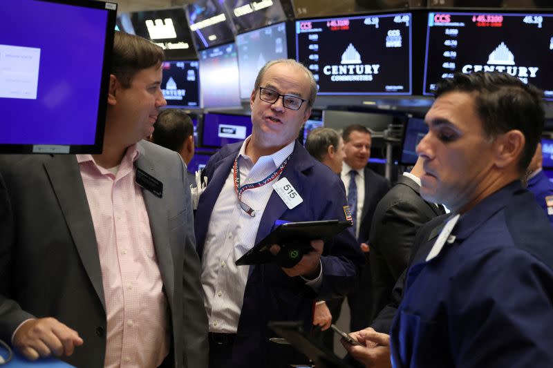 Traders work on the floor of the NYSE in New York