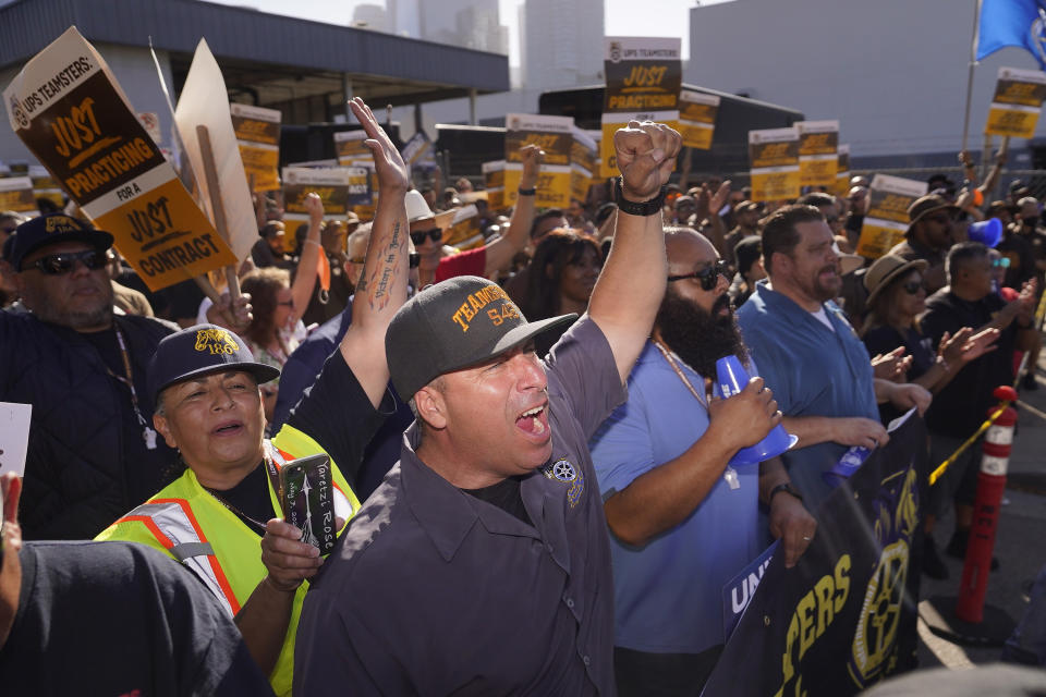 FILE - UPS Teamsters and workers hold a rally in downtown Los Angeles, as a national strike deadline nears on July 19, 2023. The union representing 340,000 UPS workers said Tuesday, Aug. 22, that its members voted to approve the tentative contract agreement reached last month, putting a final seal on contentious labor negotiations that threatened to disrupt package deliveries for millions of businesses and households nationwide. (AP Photo/Damian Dovarganes, File)