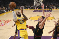Los Angeles Lakers forward LeBron James, left, shoots as Cleveland Cavaliers forward Kevin Love defends during the first half of an NBA basketball game Monday, Jan. 13, 2020, in Los Angeles. (AP Photo/Mark J. Terrill)