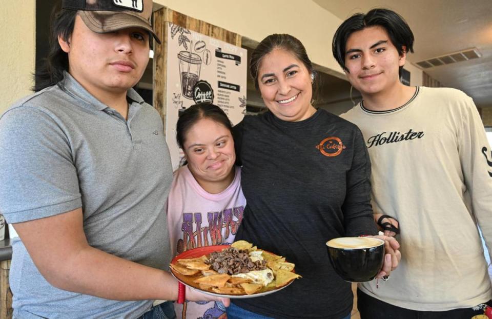 Evelyn Gutierrez-Macedo, center right, owner of Mi Cafesito, stands with members of her family at the cafe’s new location at Van Ness and Home avenues in the Tower District. From left is nephew Isaak Gutierrez, niece Diana Gutierrez, and son Khotan Macedo.