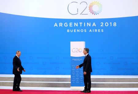 Russia's President Vladimir Putin is welcomed by Argentina's President Mauricio Macri as he arrives for the G20 leaders summit in Buenos Aires, Argentina November 30, 2018. REUTERS/Marcos Brindicci