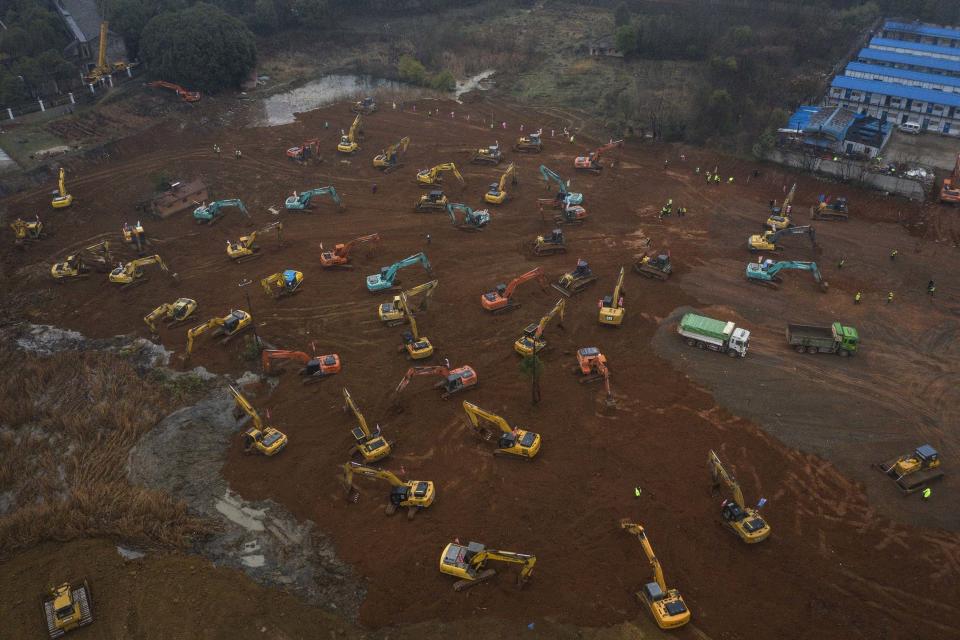 Workers driving diggers at the construction site of a hospital in Wuhan (Getty Images)