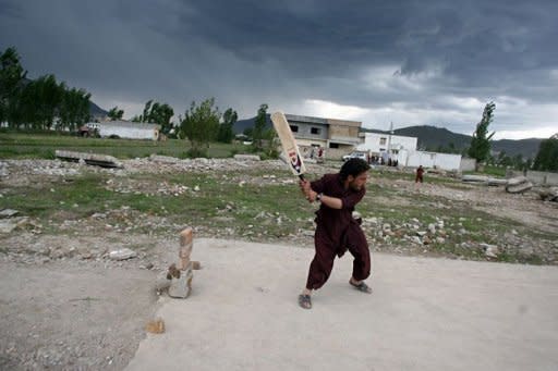 Local residents play cricket at the site of the demolished compound of slain Al-Qaeda leader Osama bin Laden in northern Abbottabad. Pakistan was in a state of high alert Wednesday over fears terrorists could mark the first anniversary of Osama bin Laden's killing by American Navy SEALs with revenge attacks