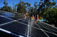 Solar installers from Baker Electric place solar panels on the roof of a residential home in Scripps Ranch, San Diego, California, U.S. October 14, 2016. Picture taken October 14, 2016. REUTERS/Mike Blake