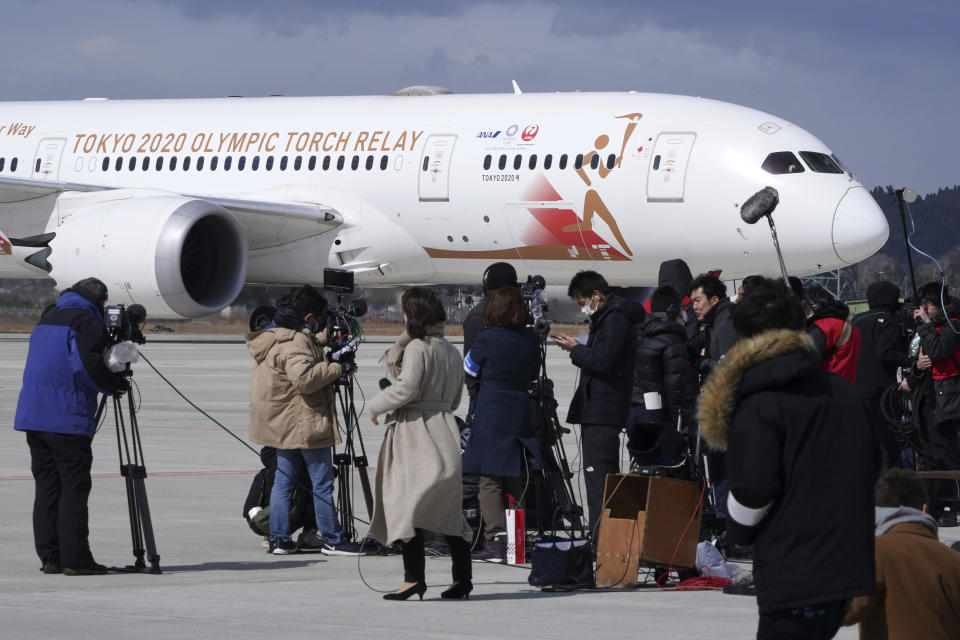 A plane carrying the Olympic flame arrives before Olympic Flame Arrival Ceremony at Japan Air Self-Defense Force Matsushima Base in Higashimatsushima in Miyagi Prefecture, north of Tokyo, Friday, March 20, 2020. The Olympic flame from Greece is set to arrive in Japan even as the opening of the the Tokyo Games in four months is in doubt with more voices suggesting the games should to be postponed or canceled because of the worldwide virus pandemic. (AP Photo/Eugene Hoshiko)