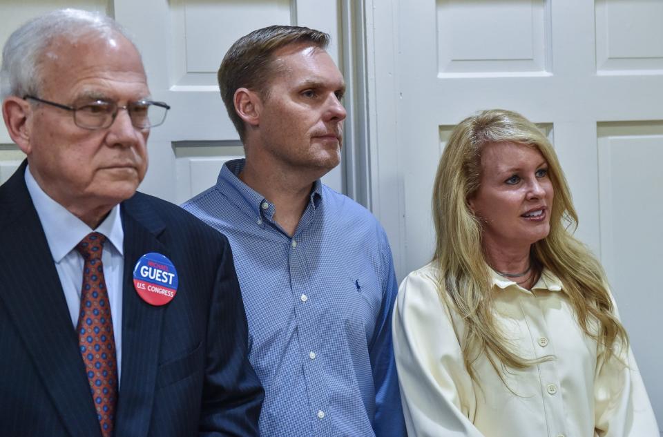 Dr. Cooper, Michael Guest's pastor, stands next to Michael and Haley Guest at an election party for the 2022 midterm elections at the Republican Party Headquarters in Jackson, Miss., November 8, 2022.