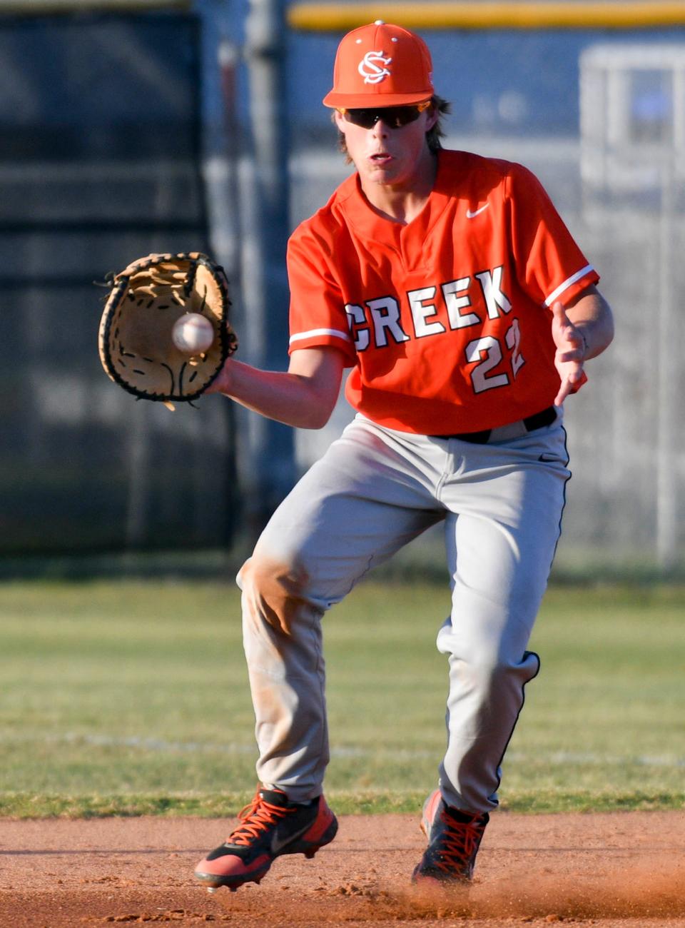 Spruce Creek's Shane Lavin fields a bouncing ball while playing first base during his sophomore season in 2022.