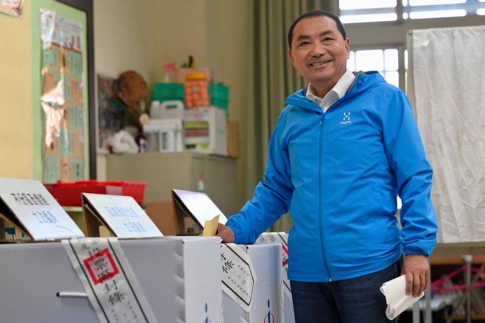 Taiwan's presidential candidate Hou Yu-ih of the main opposition Kuomintang (KMT) party casts his ballot as he votes in the presidential election in New Taipei City on January 13, 2024.