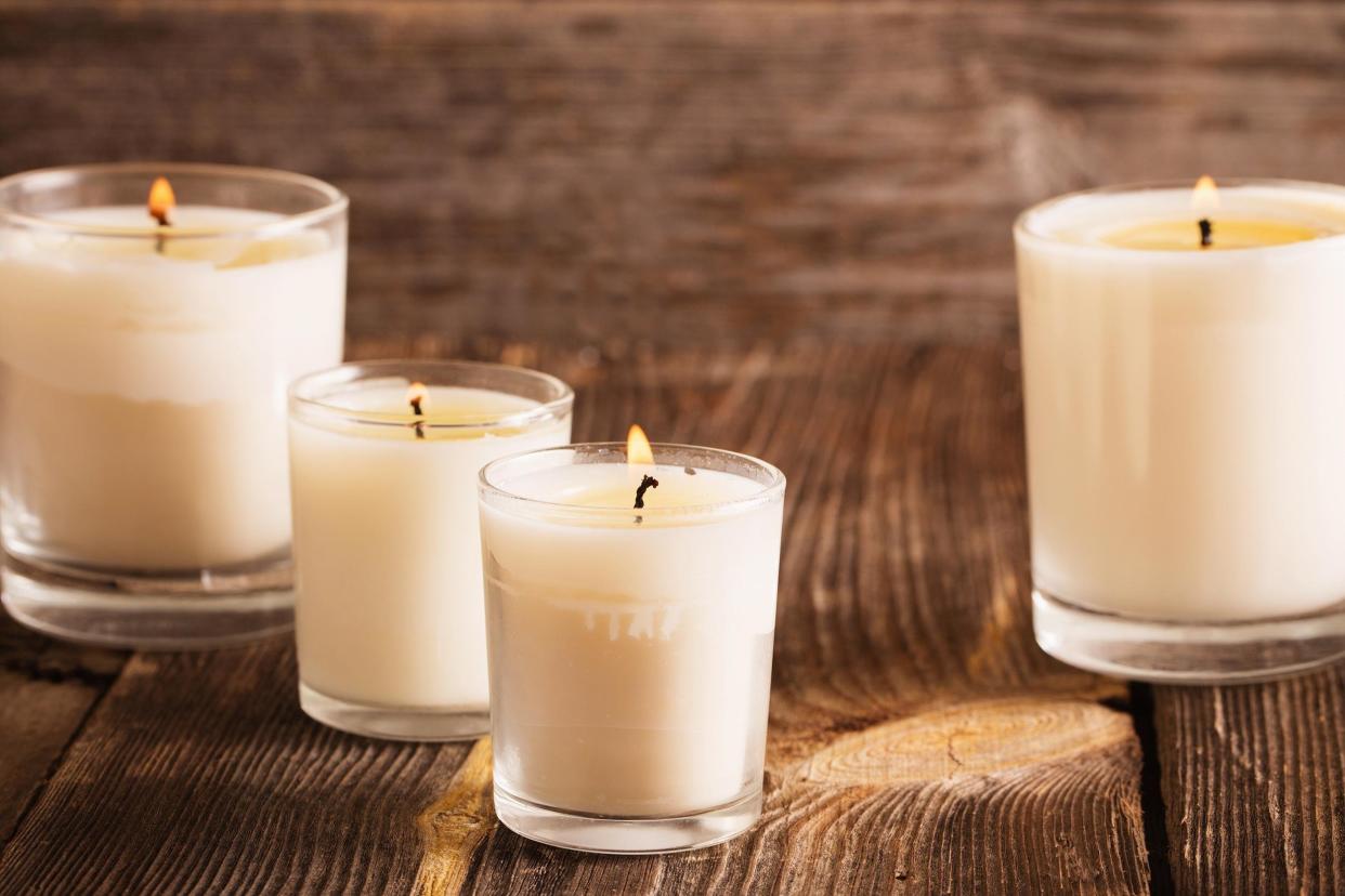 scented candles on old wooden background