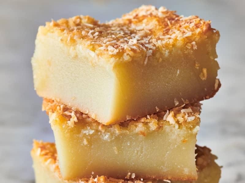 Hawaiian butter mochi sits stacked on top of each other