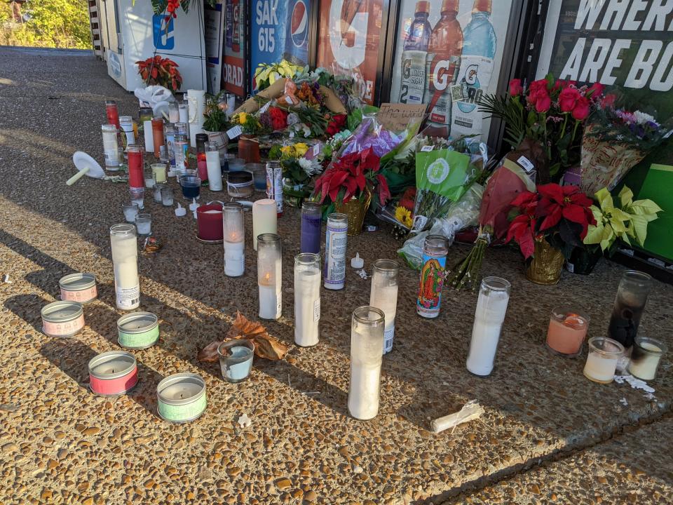 Candles and flowers lay next to the front entrance of the Kwik Sak in Hermitage where Vishal Patel was fatally shot.