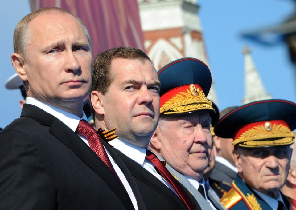 Russian President Vladimir Putin, left, and Prime Minister Dmitry Medvedev attend a Victory Day parade, which commemorates the 1945 defeat of Nazi Germany, at Red Square in Moscow, Russia, Friday, May 9, 2014. Russia marked the Victory Day on May 9 holding a military parade at Red Square. (AP Photo/RIA-Novosti, Mikhail Klimentyev, Presidential Press Service)