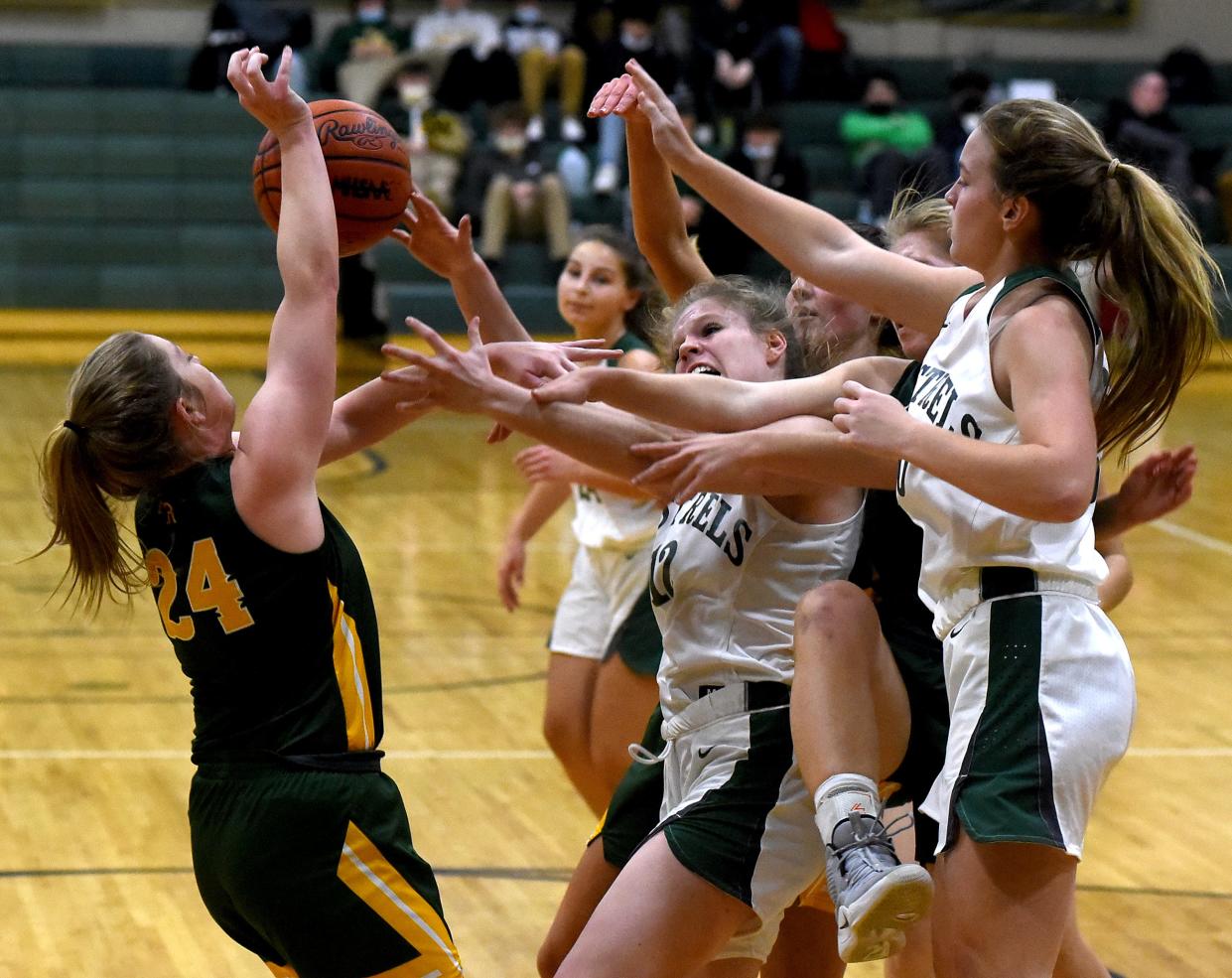 Battling underneath for a rebound Audrey Cousino of SMCC and Sophia Somerset of Flat Rock, along with Abigail Goldobin of Flat Rock and Ava Kuehnlein of SMCC Thursday, December 16, 2021.