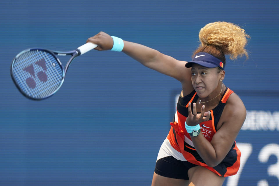 Naomi Osaka of Japan serves to Alison Riske, during the Miami Open tennis tournament, Monday, March 28, 2022, in Miami Gardens, Fla. (AP Photo/Wilfredo Lee)