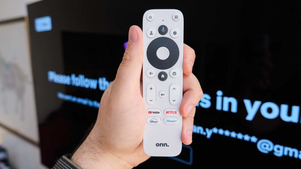 The onn 4K Google TV streaming box remote in front of a TV