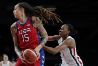 United States' Brittney Griner (15), left, drives past France's Sandrine Gruda (7) during women's basketball preliminary round game at the 2020 Summer Olympics, Monday, Aug. 2, 2021, in Saitama, Japan. (AP Photo/Charlie Neibergall)