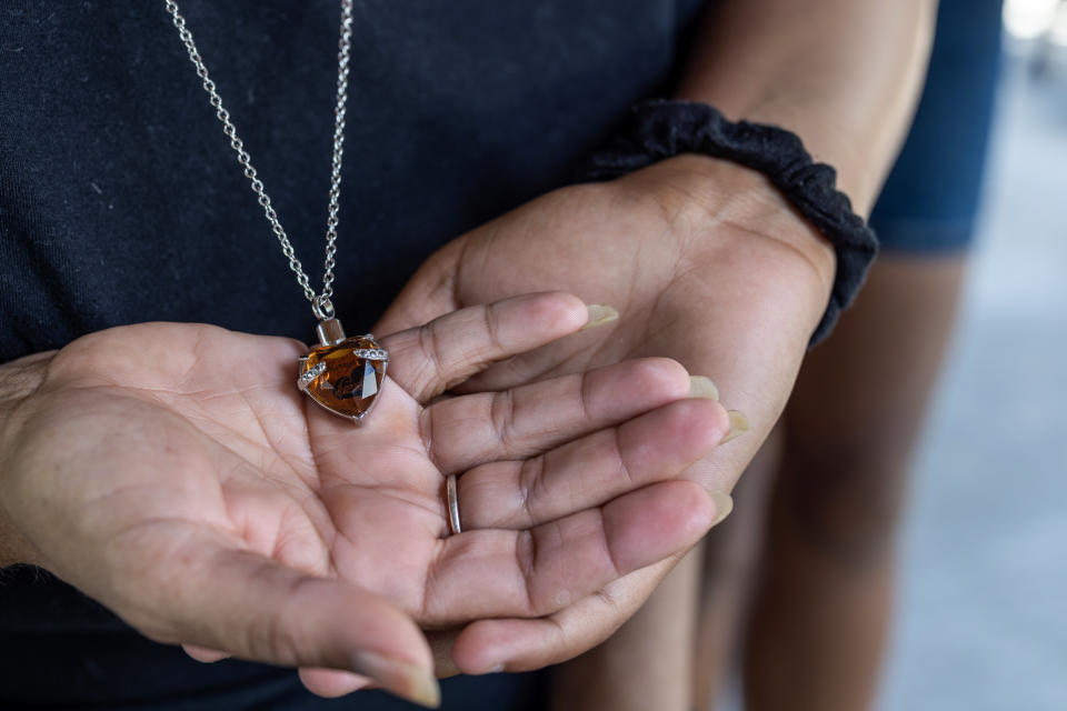 Tia Mosley carries the ashes of her son, Caleb, in a necklace. (L. Kasimu Harris for NBC News)